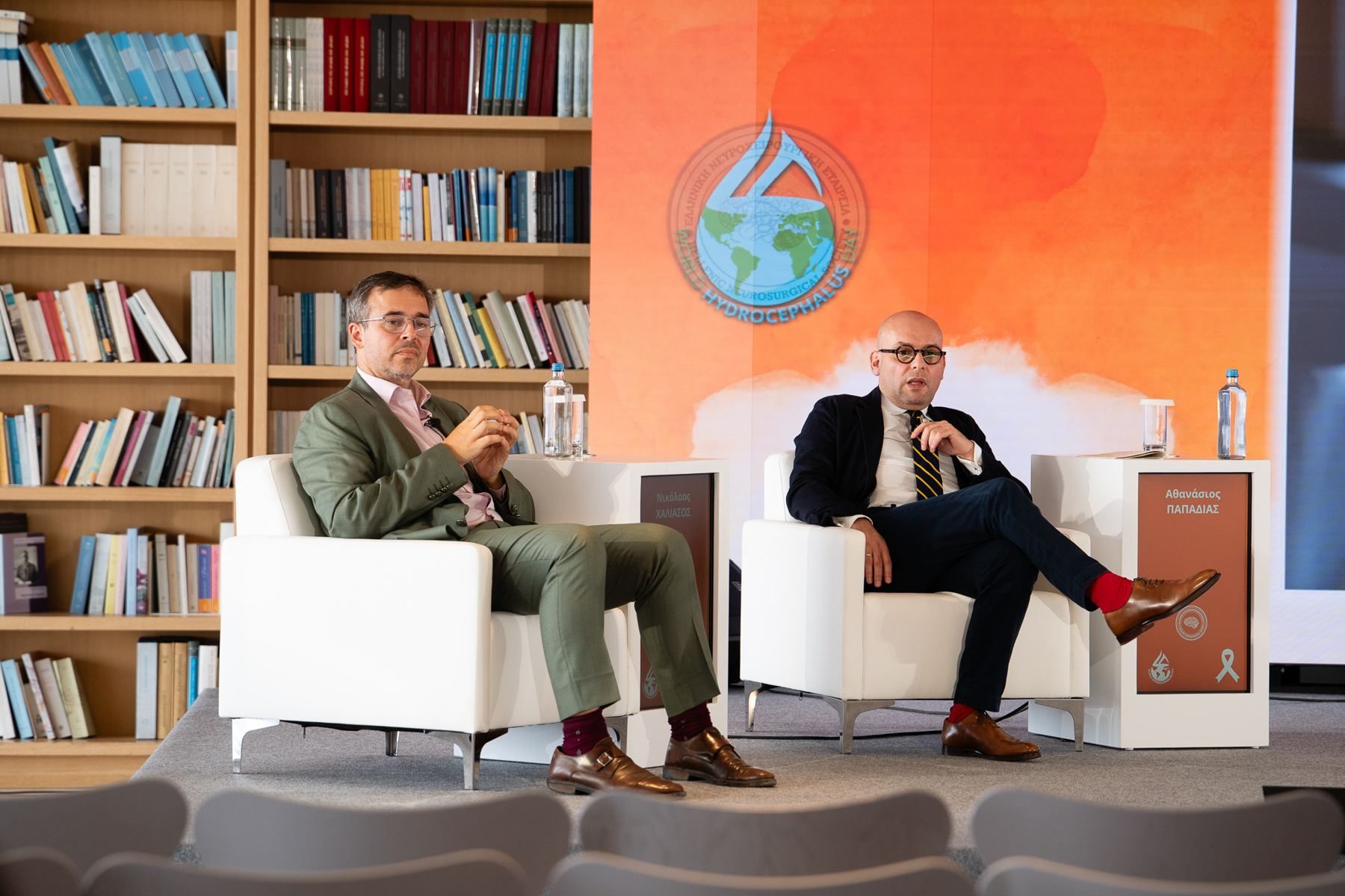 Lounge-style panel seating with the hydrocephalus awareness backdrop