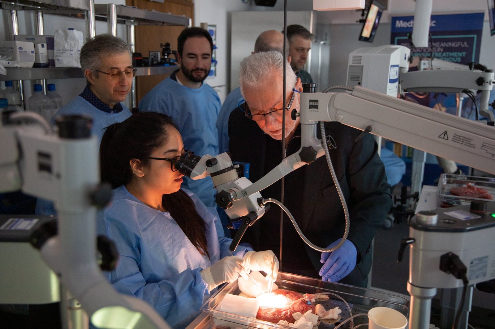 Instructor and participant at a microscope station
