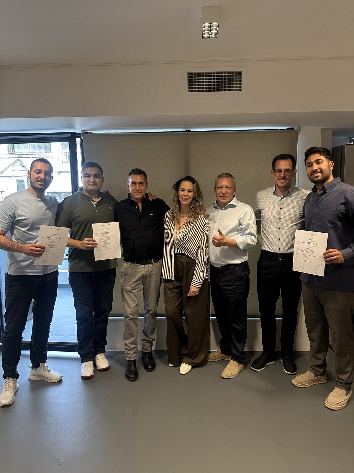 Faculty and participants with their certificates